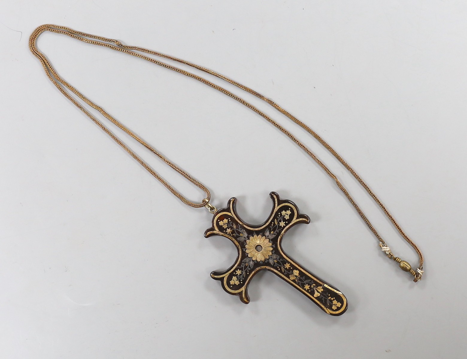 A Victorian tortoiseshell and yellow metal pique cross pendant, 73mm, on a gilt metal chain.